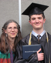 Helen standing with Daniel at his High School graduation
